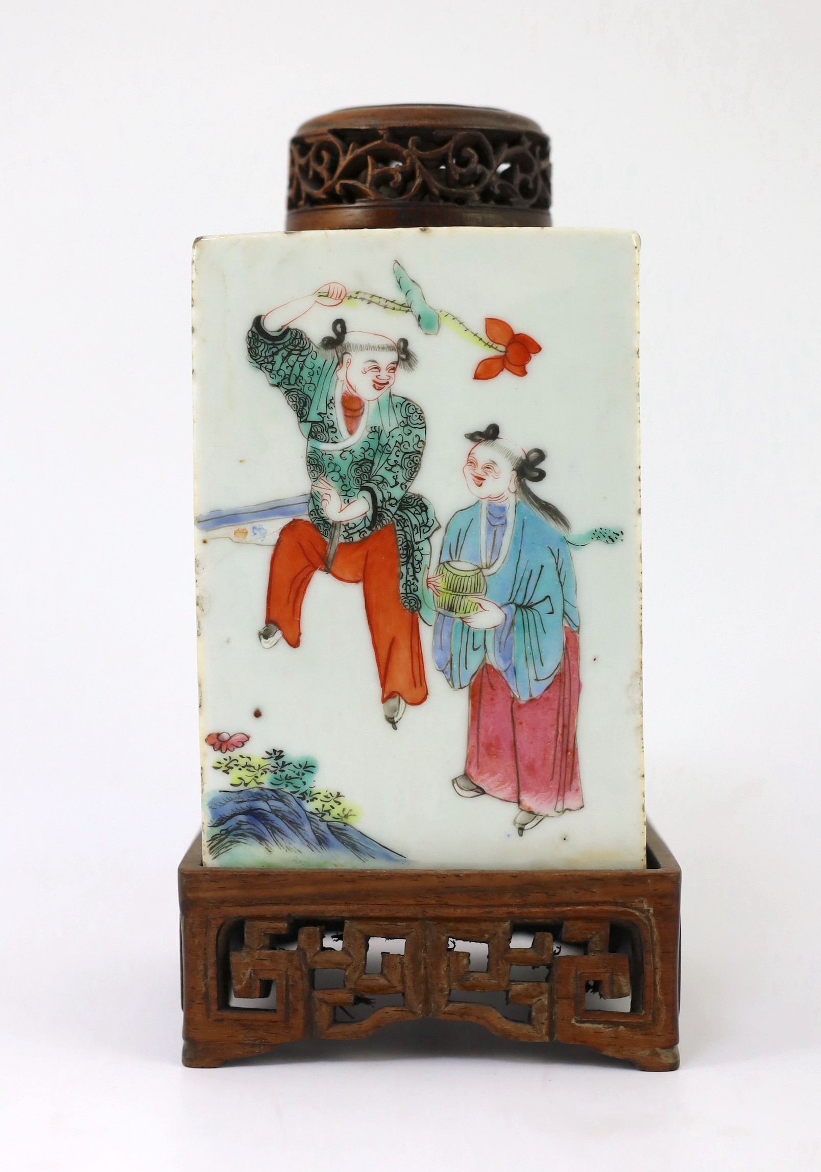 A Chinese famille rose square tea caddy, mid 19th century, 13.7cm high excluding wood stand and cover, slight damage